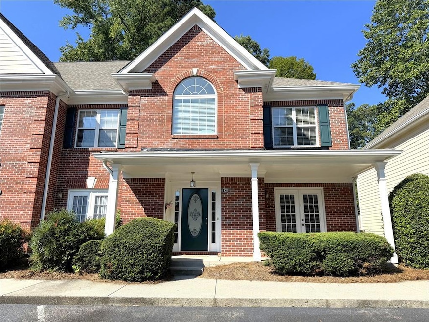 Traditional-style home with brick siding and covered porch