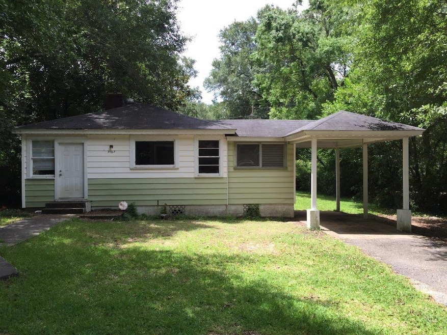 View of front of home with driveway, a carport, a front yard, and entry steps