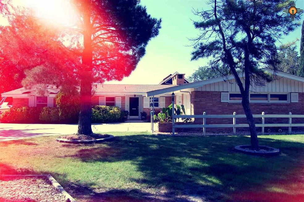 There is tons of front yard space and shade trees along with a very long driving curving to garage.