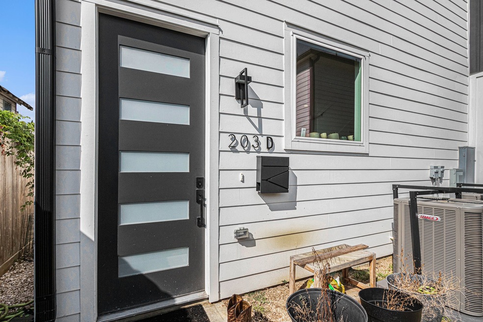 Modern exterior with a sleek black door featuring frosted glass panels.