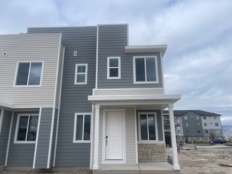 View of front of property featuring a porch and stone siding
