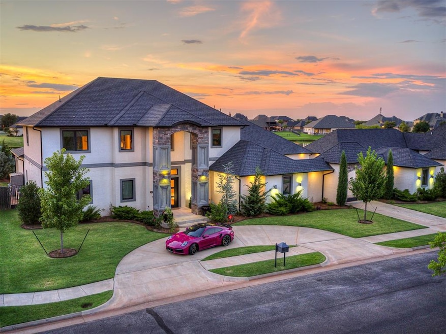 French country inspired facade featuring curved driveway, a shingled roof, stucco siding, stone siding, and a lawn