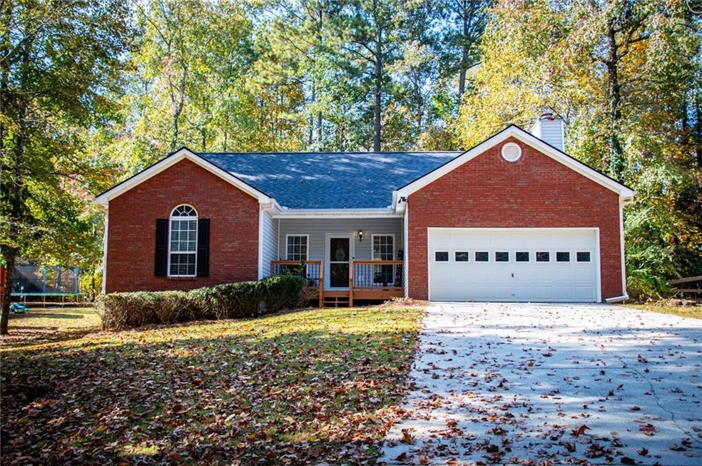 Ranch-style house featuring a trampoline, a garage