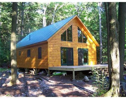 Log sided cottage with metal roof to...