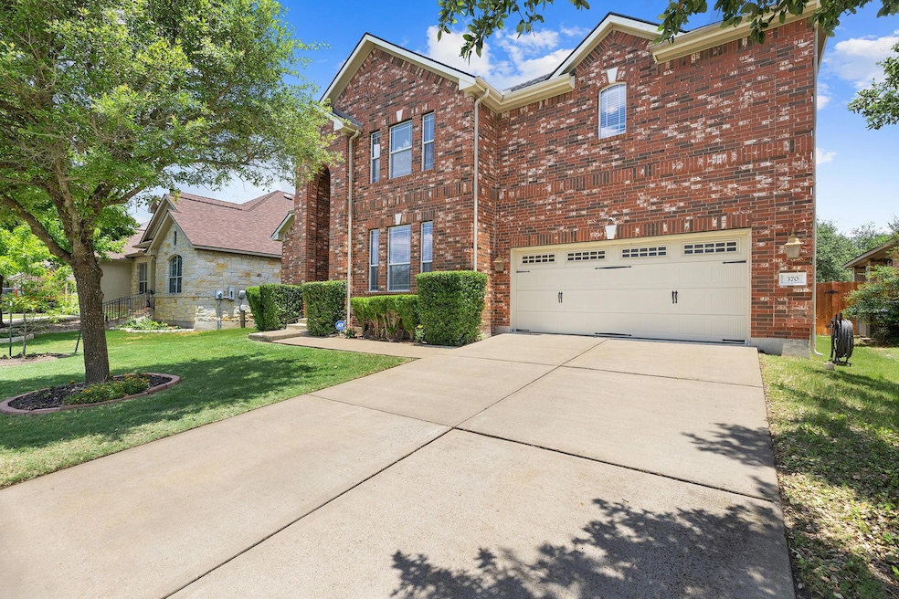 Traditional-style house featuring concrete drivew