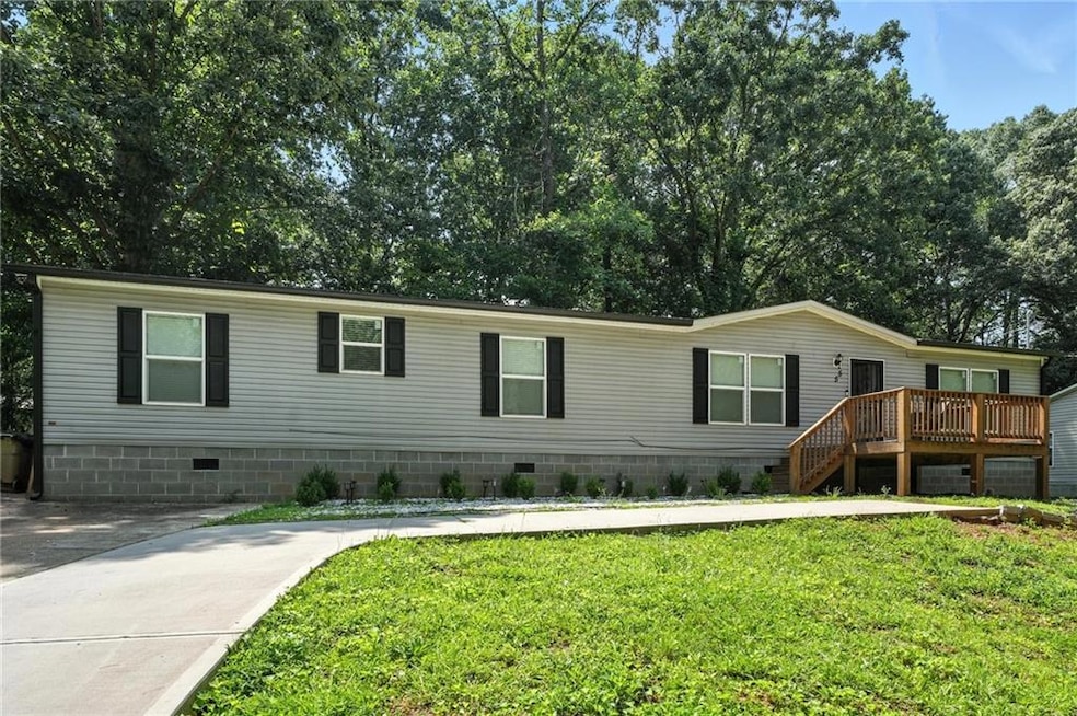 Manufactured / mobile home featuring crawl space, a front yard, and a deck