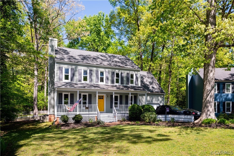 Colonial house featuring a front lawn and a porch