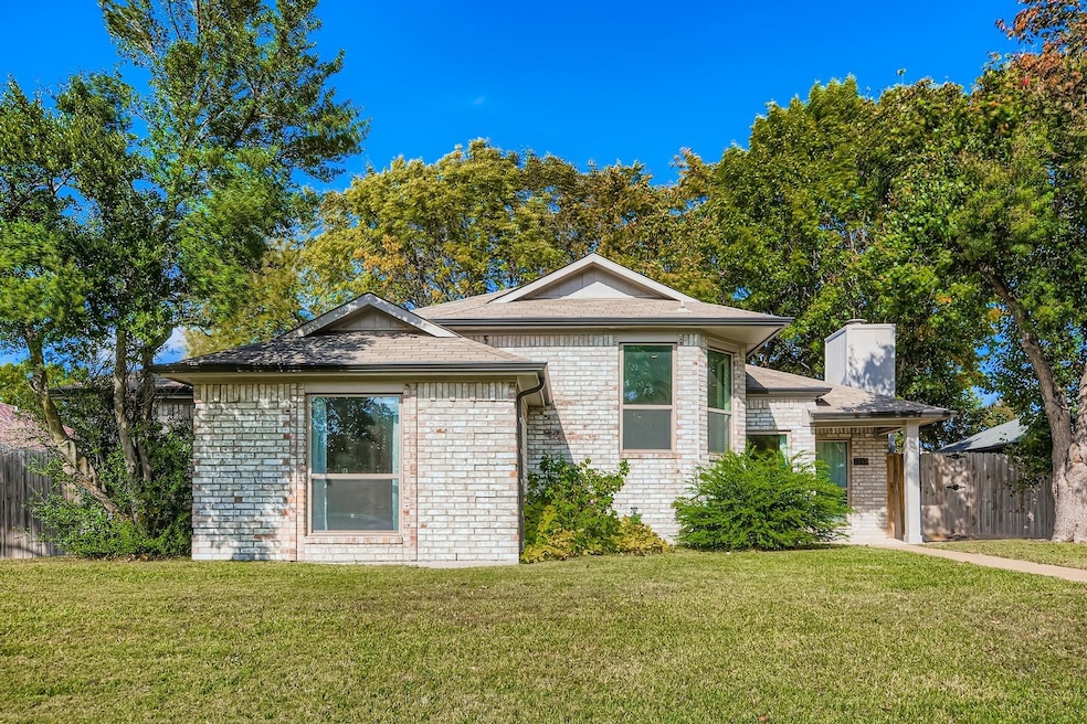 View of front of house with brick siding and a chimney
