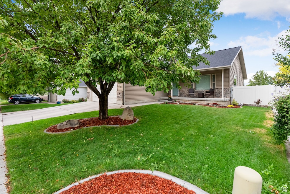 Obstructed view of property featuring concrete driveway, a shingled roof, an attached garage, and stone siding