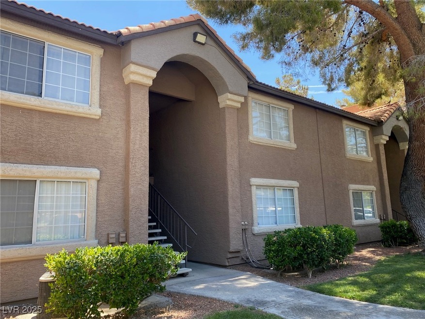 Doorway to property with stucco siding and a tiled