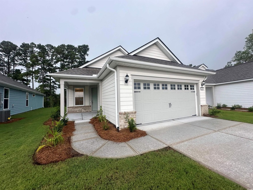 View of front of property featuring a garage, cent