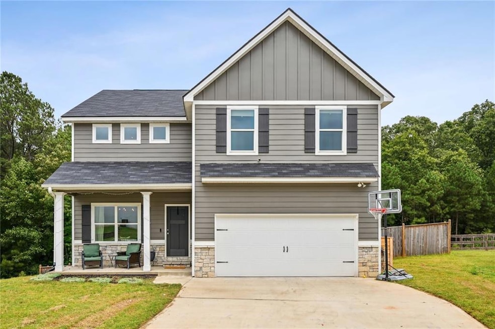 Craftsman-style house featuring a front yard, a ga