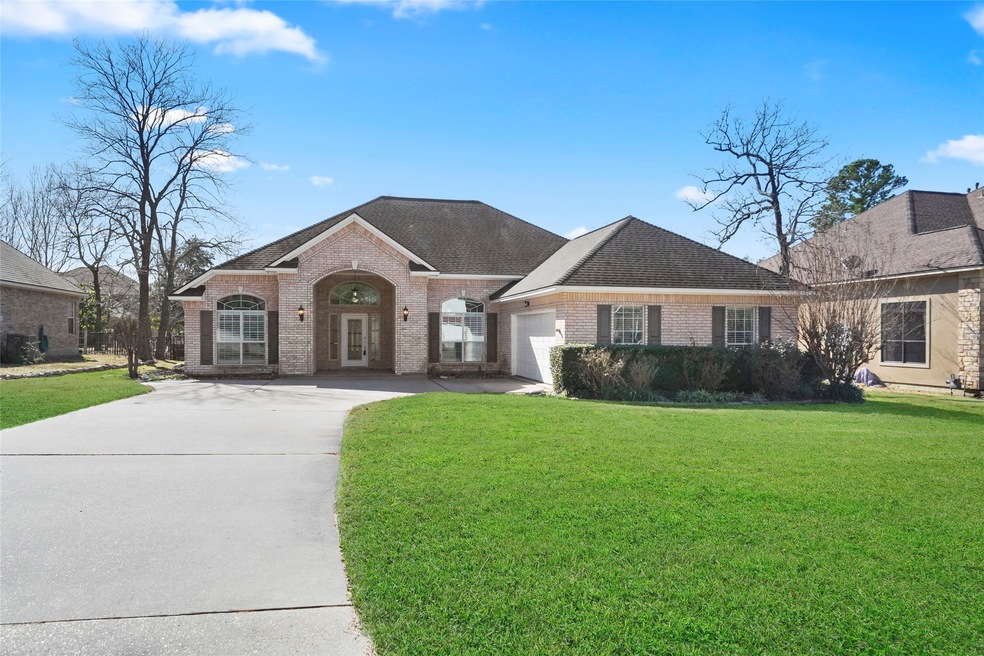 Single story brick home located within the gated community of Longmire on Lake Conroe.