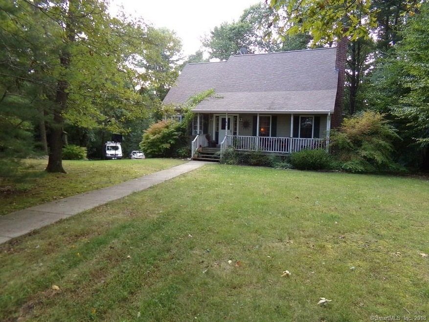 FRONT PICTURE OF HOME WITH A COVERED FARMERS PORCH