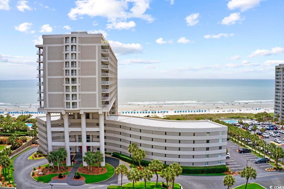 View of building exterior with a beach view and a 