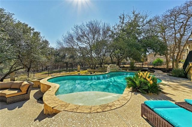Featuring a sparkling pool & lounging area. A section of the backyard is fully fenced, but the acreage stretches well beyond the fence into your own private greenbelt!