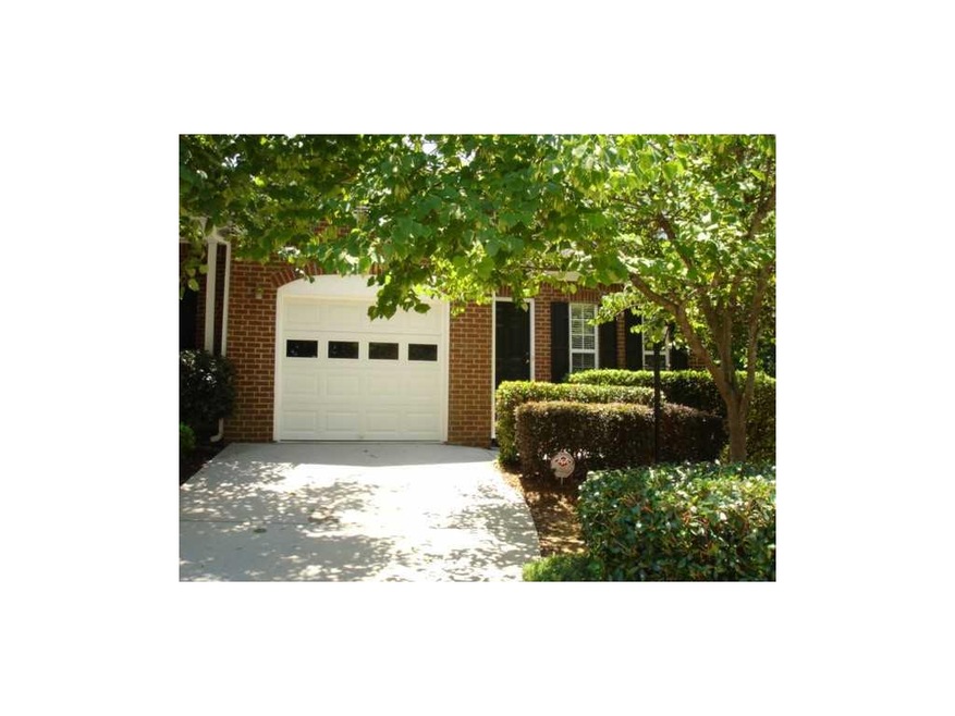 Exterior Front. The front facade is shaded by a lo