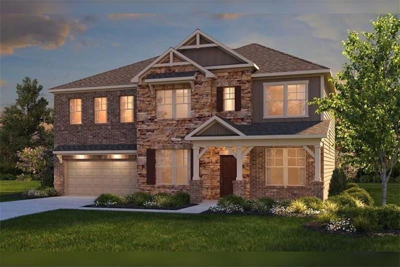 View of front of home with a garage, a lawn, concr