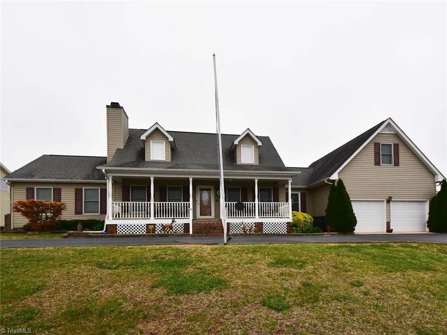 Classic Cape Cod with welcoming front porch and two car garage