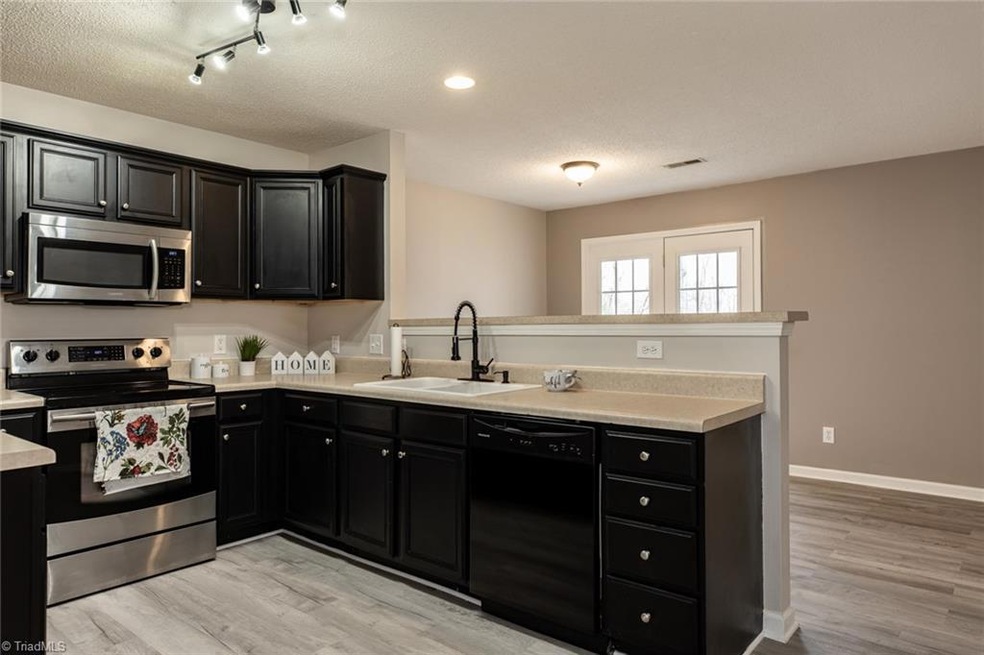 Kitchen and dining area in background