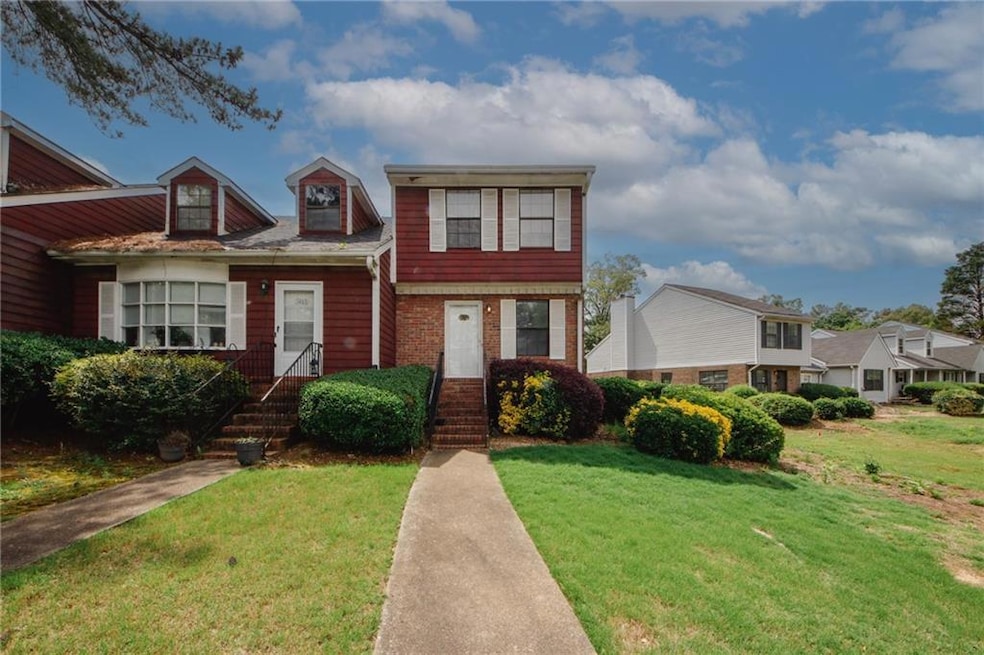 View of front of house featuring a front lawn and brick siding