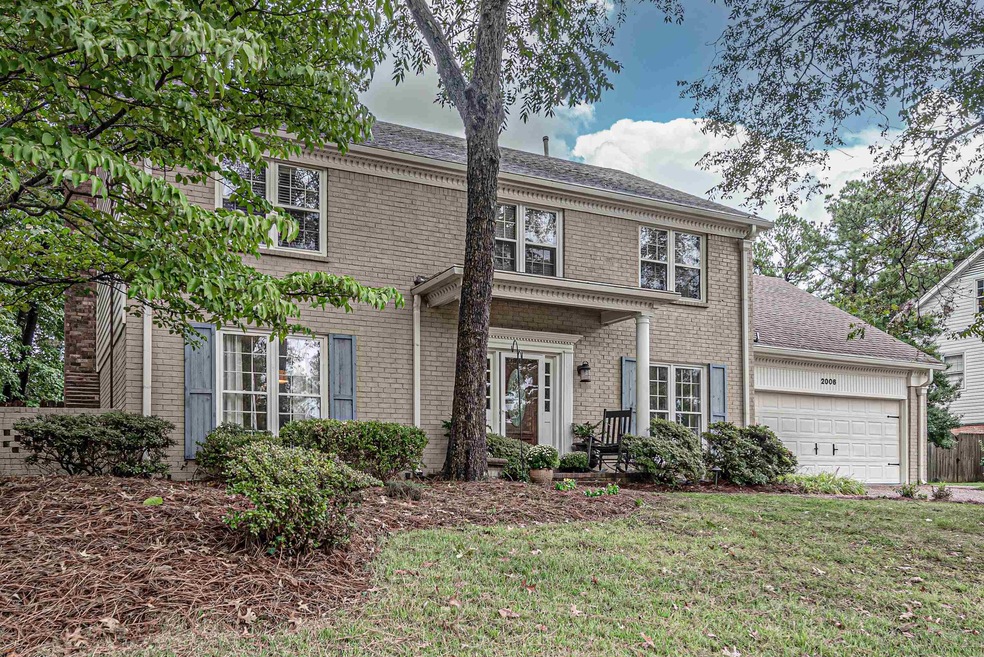View of front of home with a garage and a front la