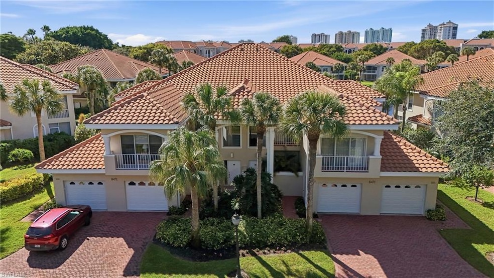 Mediterranean / spanish-style home with a balcony, stucco siding, a tiled roof, and a residential view