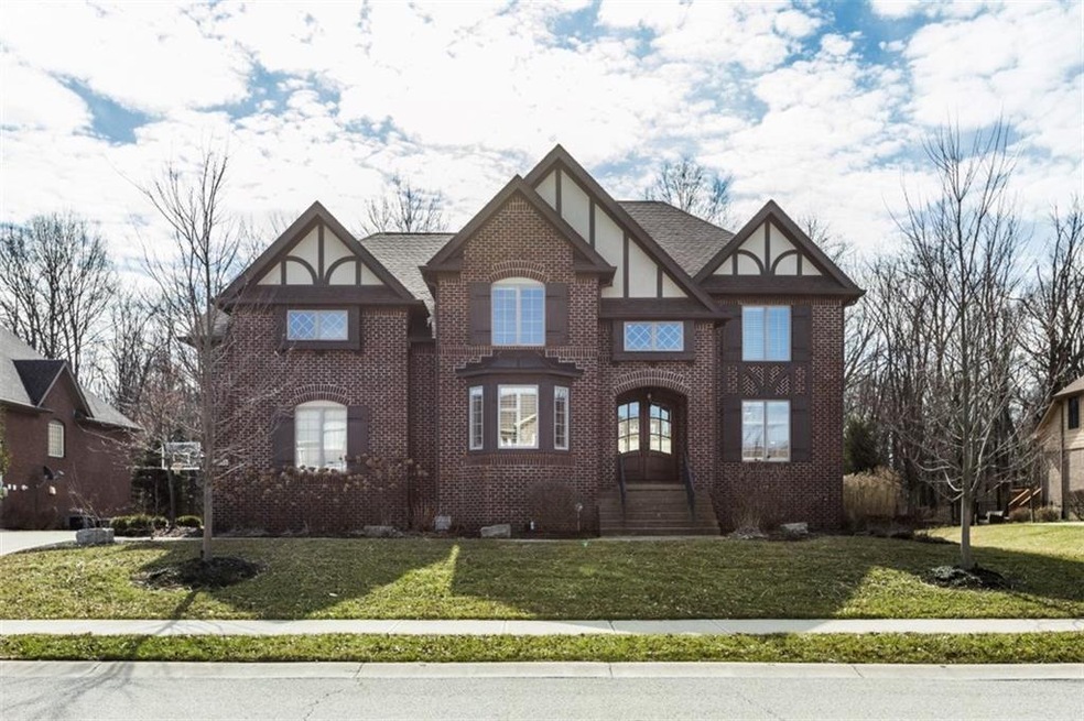 3261 WHISPERING PINES LANE IS A BRICK-FACED TUDOR STYLE HOME IN THE SADDLEBROOK OF SHELBORNE NEIGHBORHOOD OF WEST CARMEL.  MINIMAL BUT EFFECTIVE LANDSCAPING FRAMES THIS STATELY HOME AND HELPS GIVE IT AN IMPRESSIVE FIRST IMPRESSION.