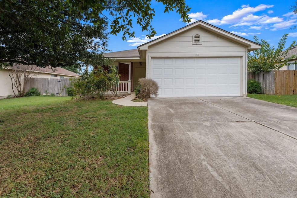 Ranch-style home featuring driveway and a garage