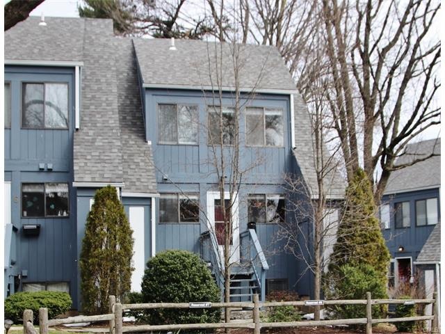 Nature surrounds the entrance to this lovely home.