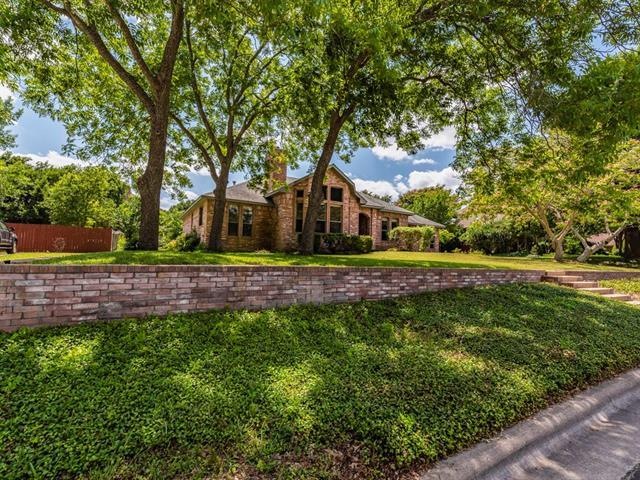 This large, green lot features gorgeous, mature tr