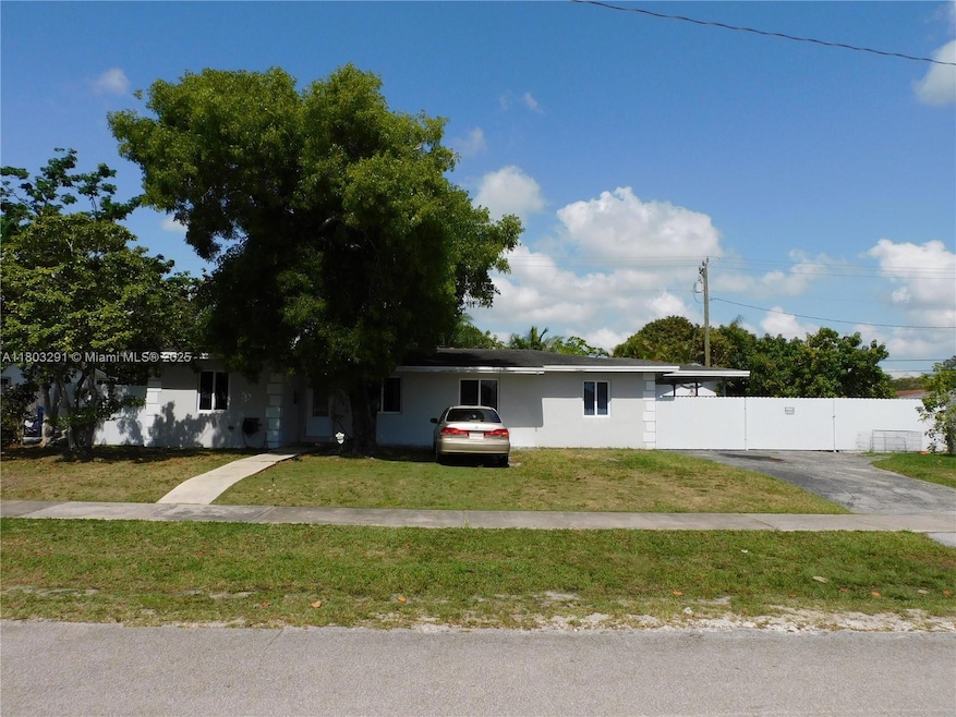 Extended driveway leads to carport and interior 1 car garage - plenty of parking.