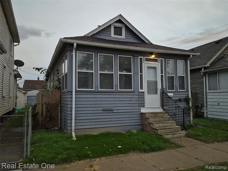 Bungalow-style house with a gate, entry steps, and roof with shingles