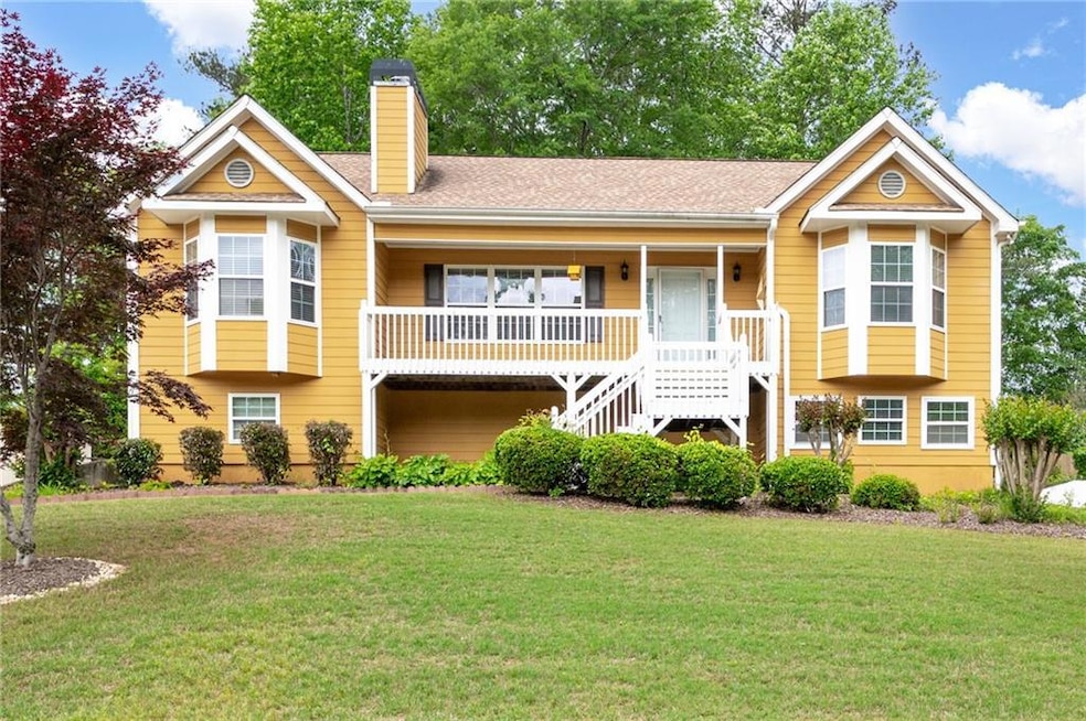View of front of home with a chimney, a front lawn