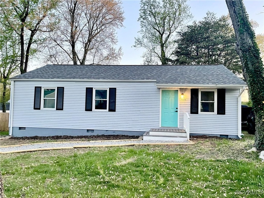 View of front facade with a front yard, roof with