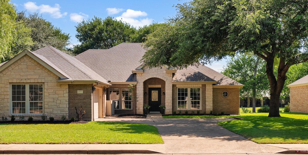 View of front of home featuring stone siding, a f