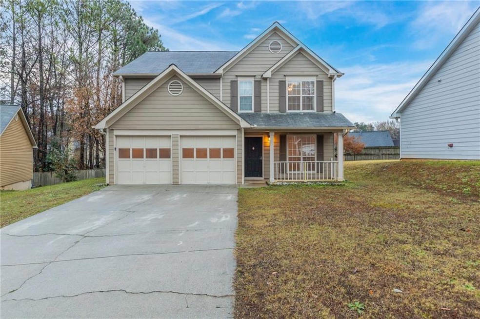 Front of property featuring a garage, covered porc