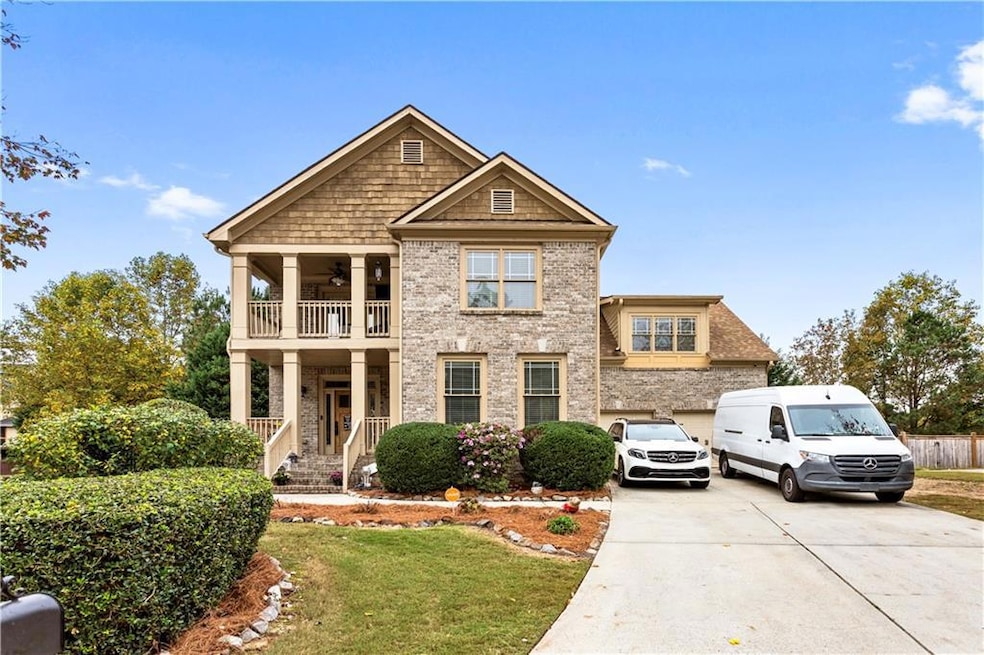 View of front facade featuring a garage, a front y