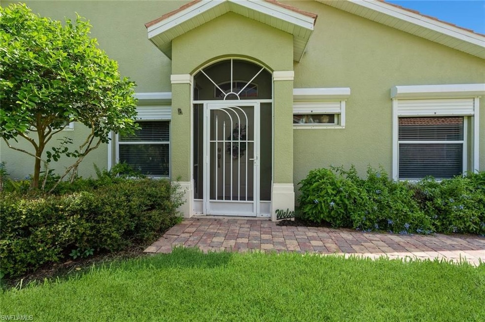 Doorway to property featuring stucco siding