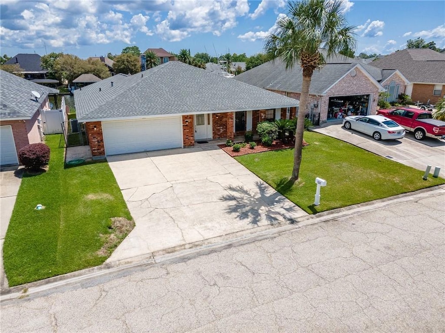 Aerial view of home with extra wide driveway. Covered from porch.  Easy maintenance with brick and vinyl.