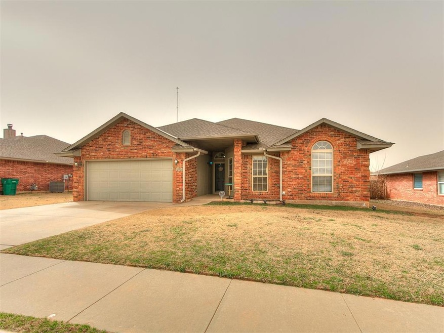 Ranch-style home with concrete driveway, an attach