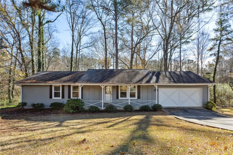 Ranch-style house featuring a garage, a front yard