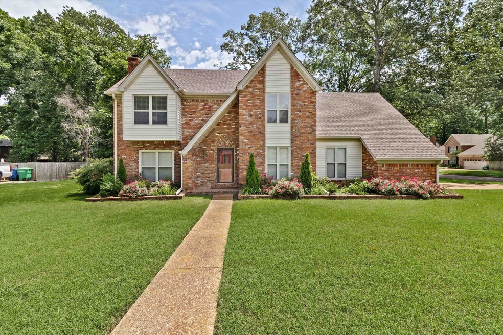 View of front of house with a shingled roof, brick