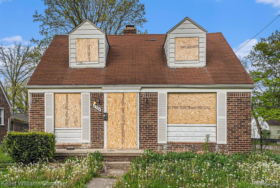 Cape cod-style house featuring brick siding, a chimney, and roof with shingles