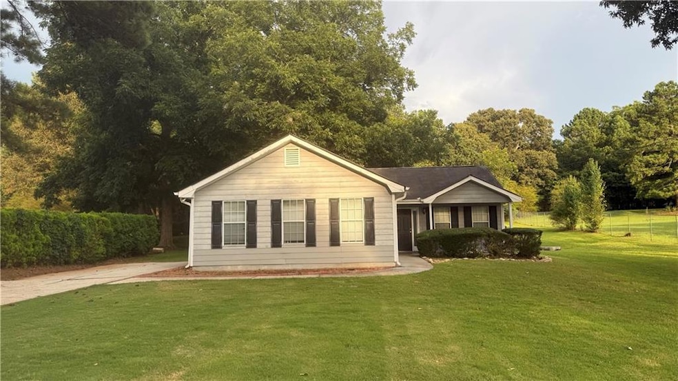 View of front of home with a front lawn and concrete driveway