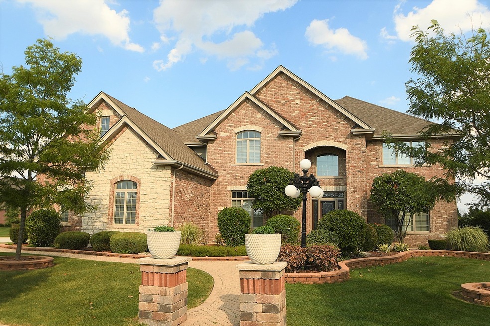 Elegant brick and stone exterior, paver sidewalk, 