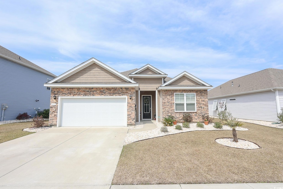 View of front of property with a garage, stone sid
