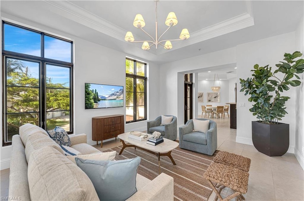 Living room with crown molding, a notable chandeli