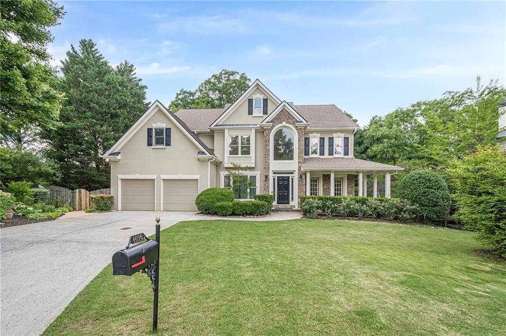 Stunning covered deck, with flowing drapery panels for a touch of privacy and style, while the grand stone fireplace serves as the captivating focal point-perfect for cozy evenings or stylish entertaining. The fireplace is seen from almost every room