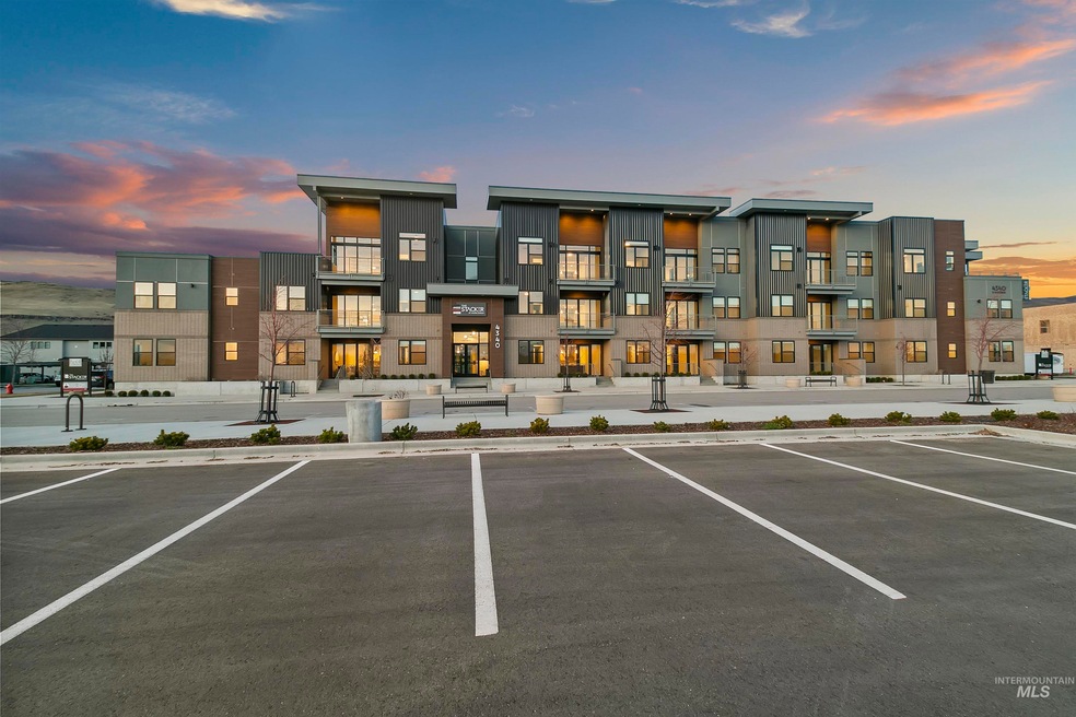 View of property featuring uncovered parking